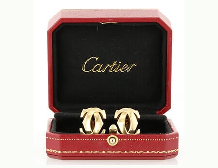 Cartier double C logo 18K gold clip-on earrings.