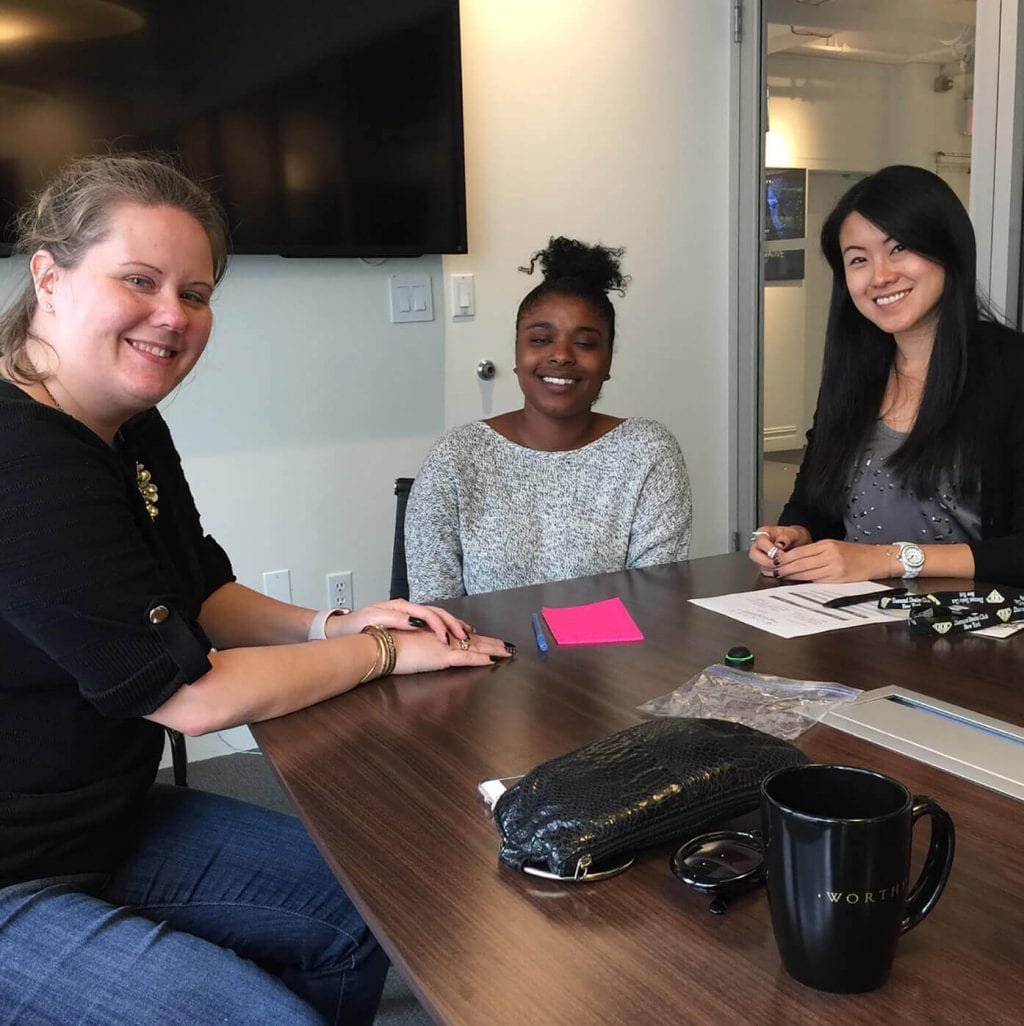 Worthy's gemologist Yingjia and customer success agent Alex assisting Janelle in the sale of her diamond ring at the Worthy NYC office.