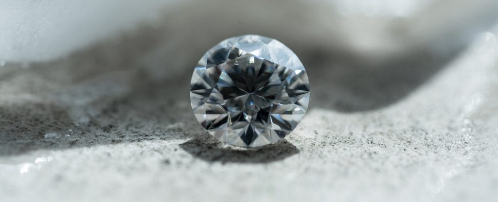 Unless you are well-trained, the best way to identify an uncut diamond is  to take it to a jeweler.
